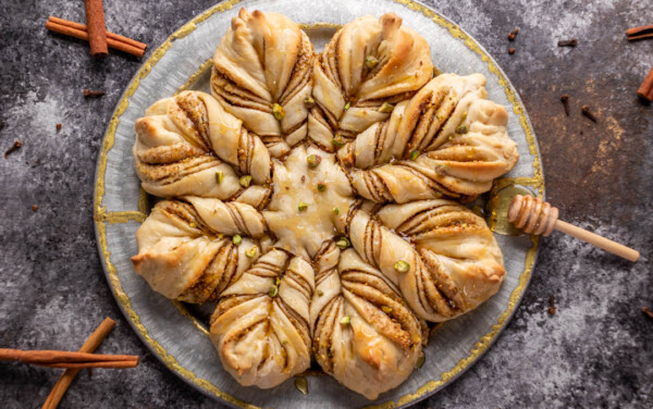 Overhead view of a loaf of Baklava star bread on a silver platter.