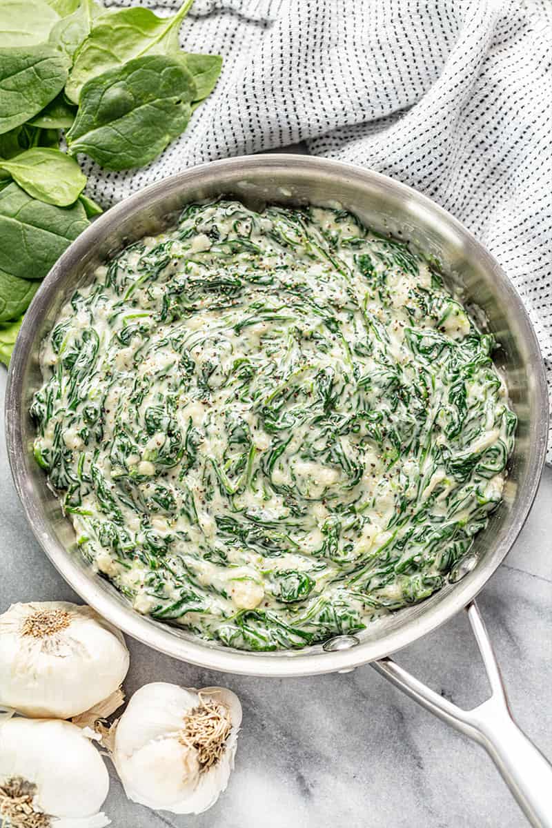 Creamed spinach in a stainless steel skillet