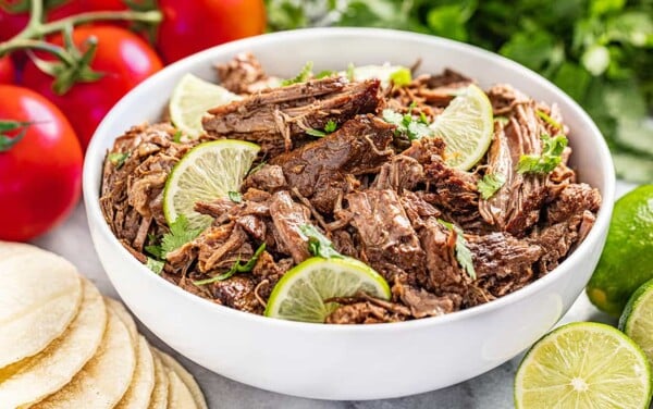 A white bowl filled with Chili lime Mexican shredded beef.