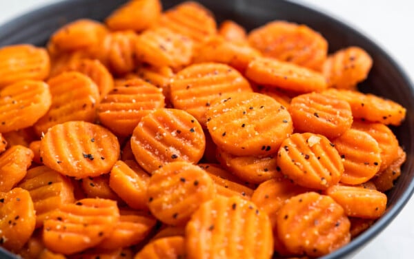 Cooked, sliced carrots in a serving bowl.