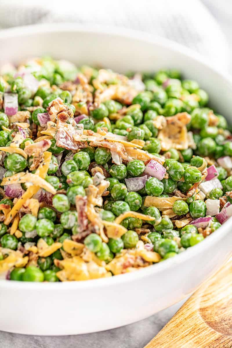 Close up view of a bowl filled with pea salad