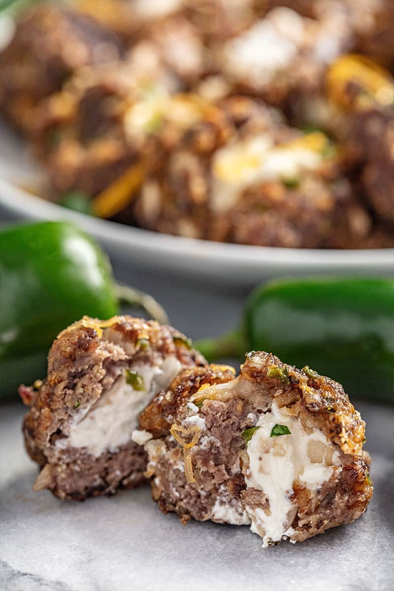 Jalapeno popper meatball cut in half with cream cheese oozing out
