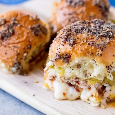 Angled view of Southwest Hawaiian Roll Turkey Sliders on a wood cutting board.