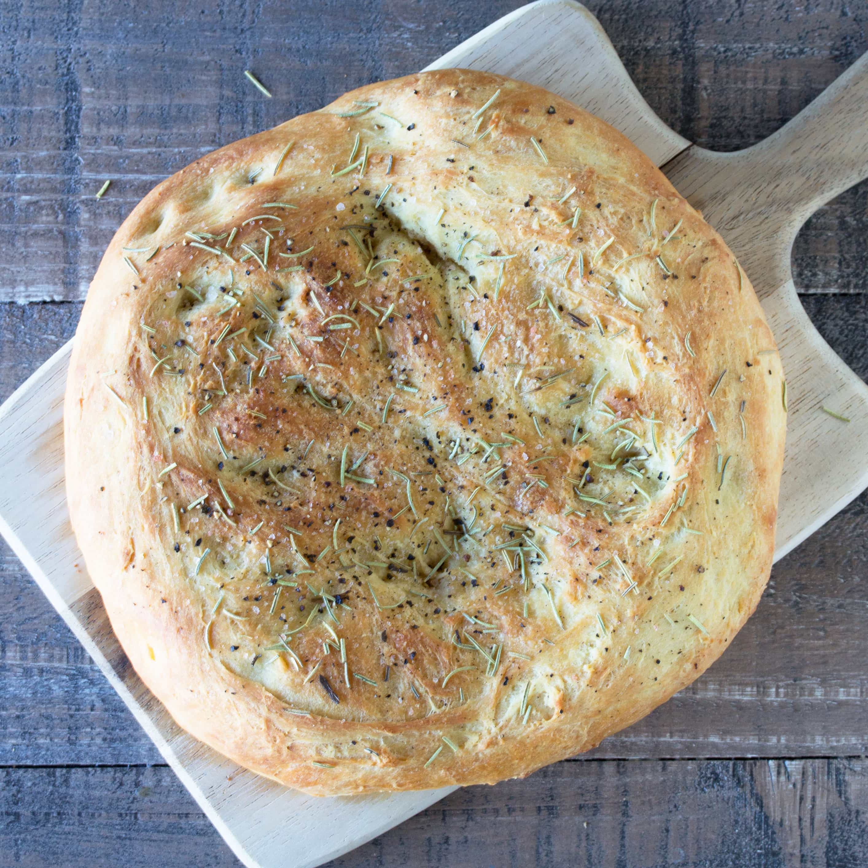 Rosemary Focaccia bread on a cutting board.