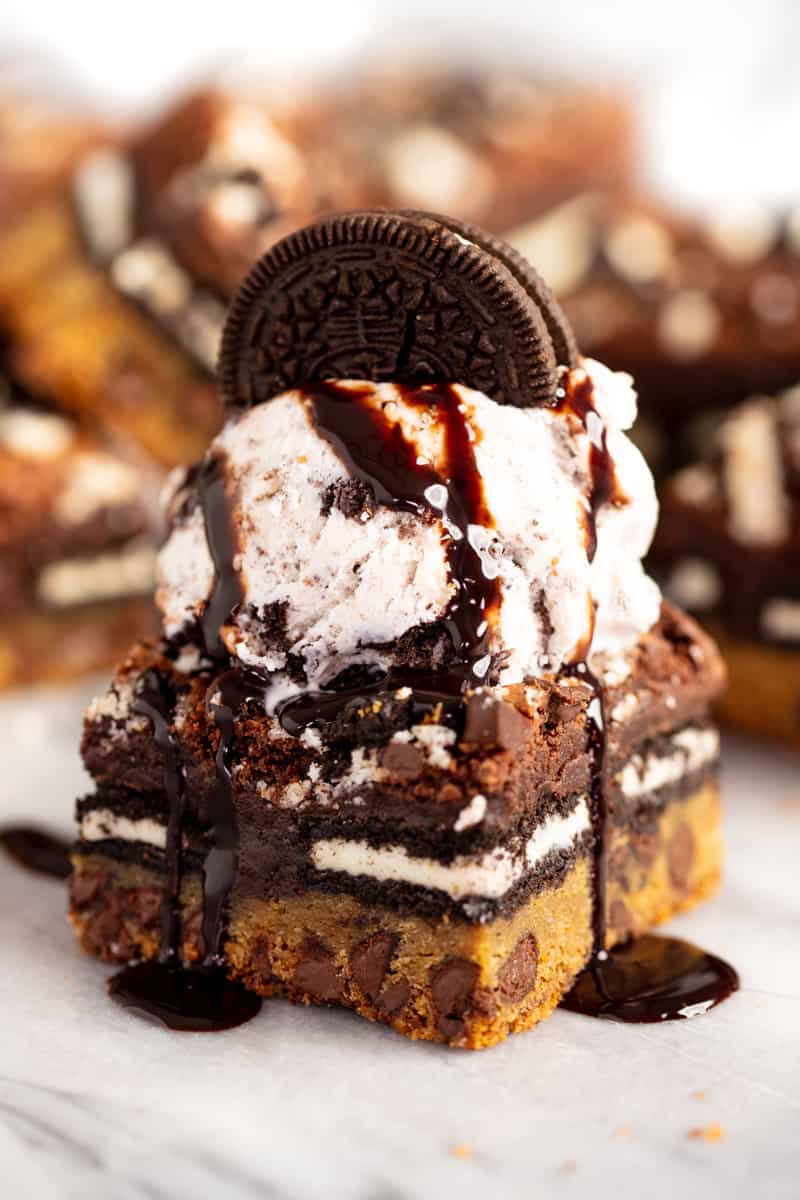 Slutty Brownie topped with a scoop of ice cream, an oreo cookie, and chocolate syrup. 