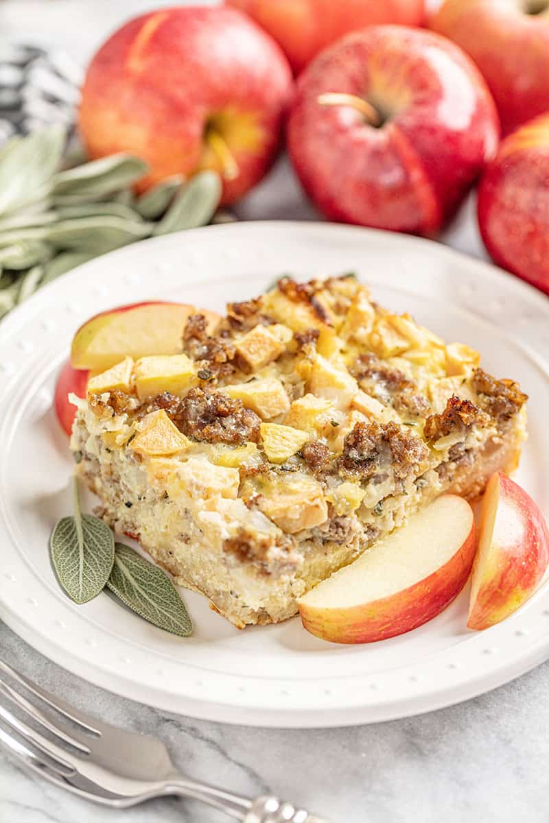 Slice of Sausage Breakfast Strata with Sage and Apple on a white plate.