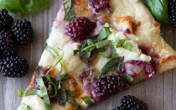 A slice of blackberry basil ricotta pizza.