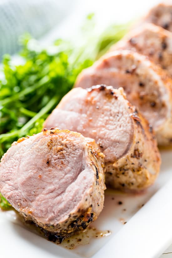 Garlic Butter Pork Tenderloin served in slices on a serving platter 