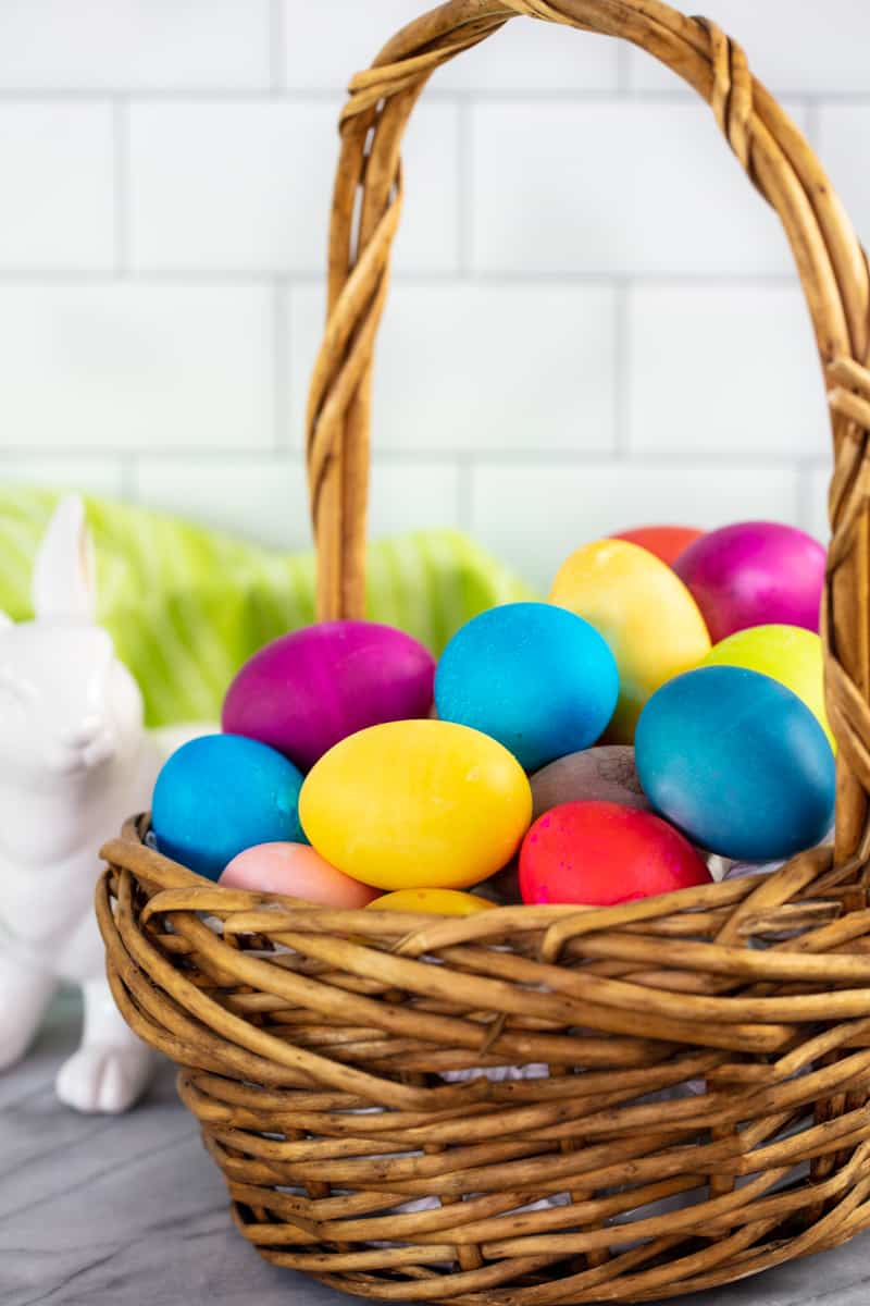 A basket full of dyed eggs.