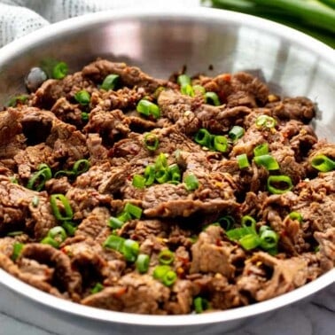 Mongolian Beef in a stainless steel skillet.