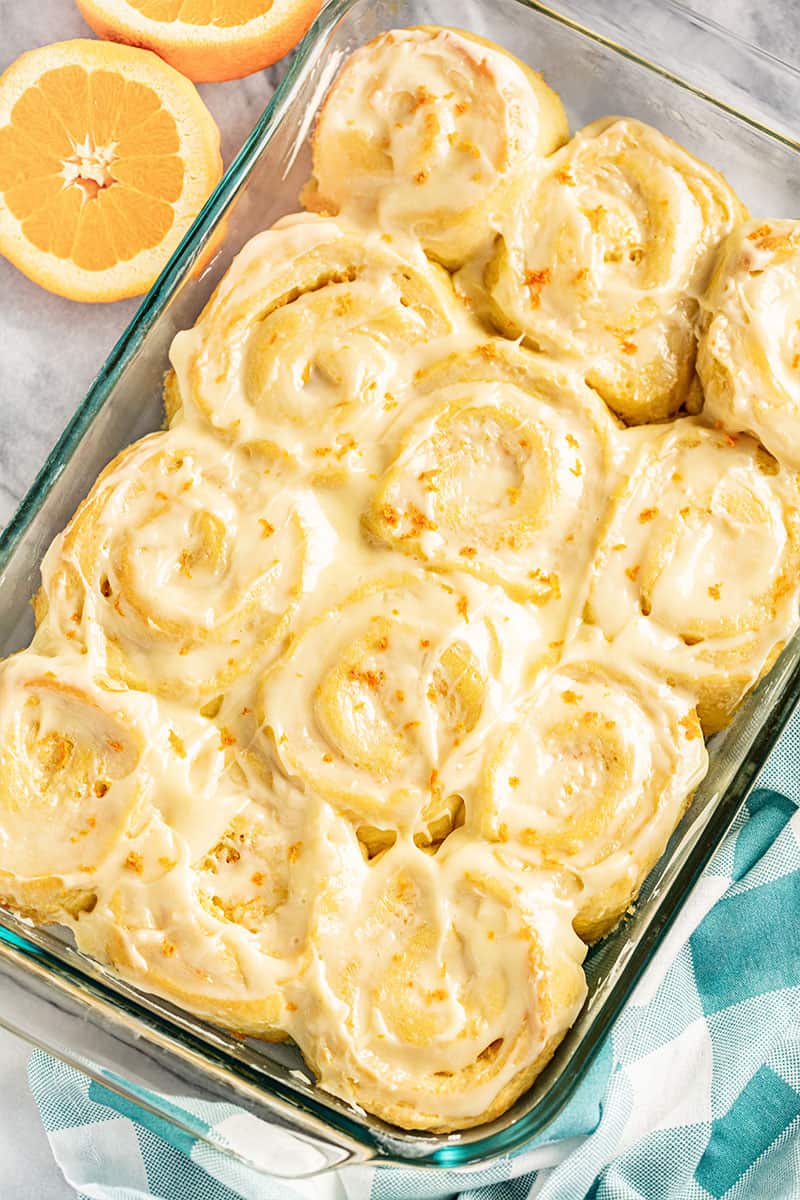 Bird's eye view of Orange Rolls in a glass pan.