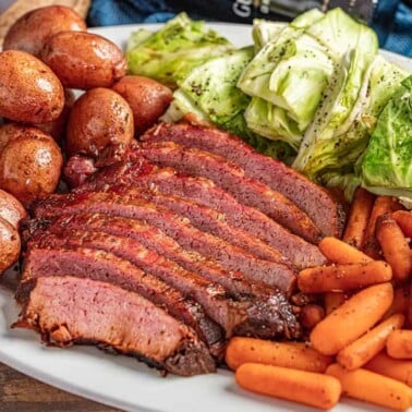 Corned beef and cabbage with carrots and potatoes on a platter.