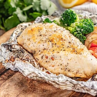 Chicken and veggies in a foil packet opened up.