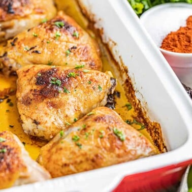 Chipotle and lime chicken thighs in a baking dish.