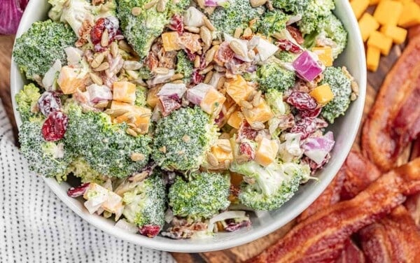 Overhead view of a large white bowl filled with classic broccoli salad.