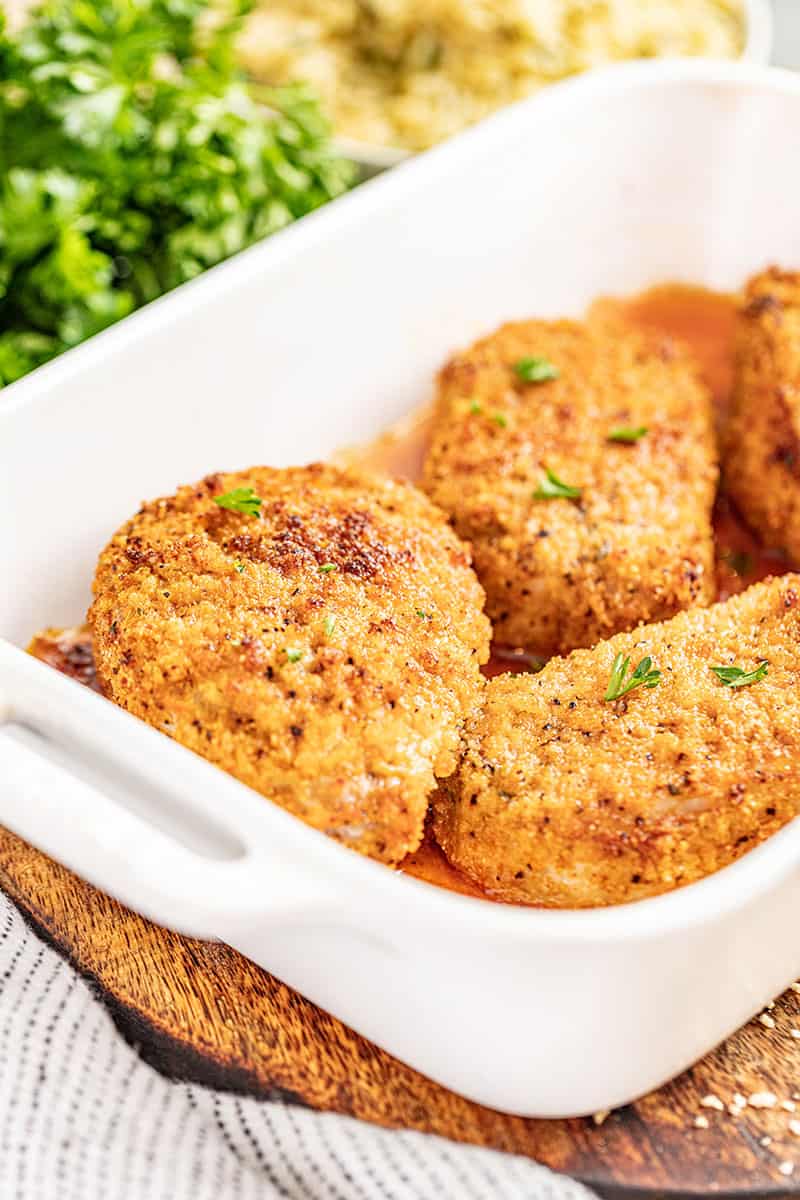 Crispy breaded pork chops in a baking dish.