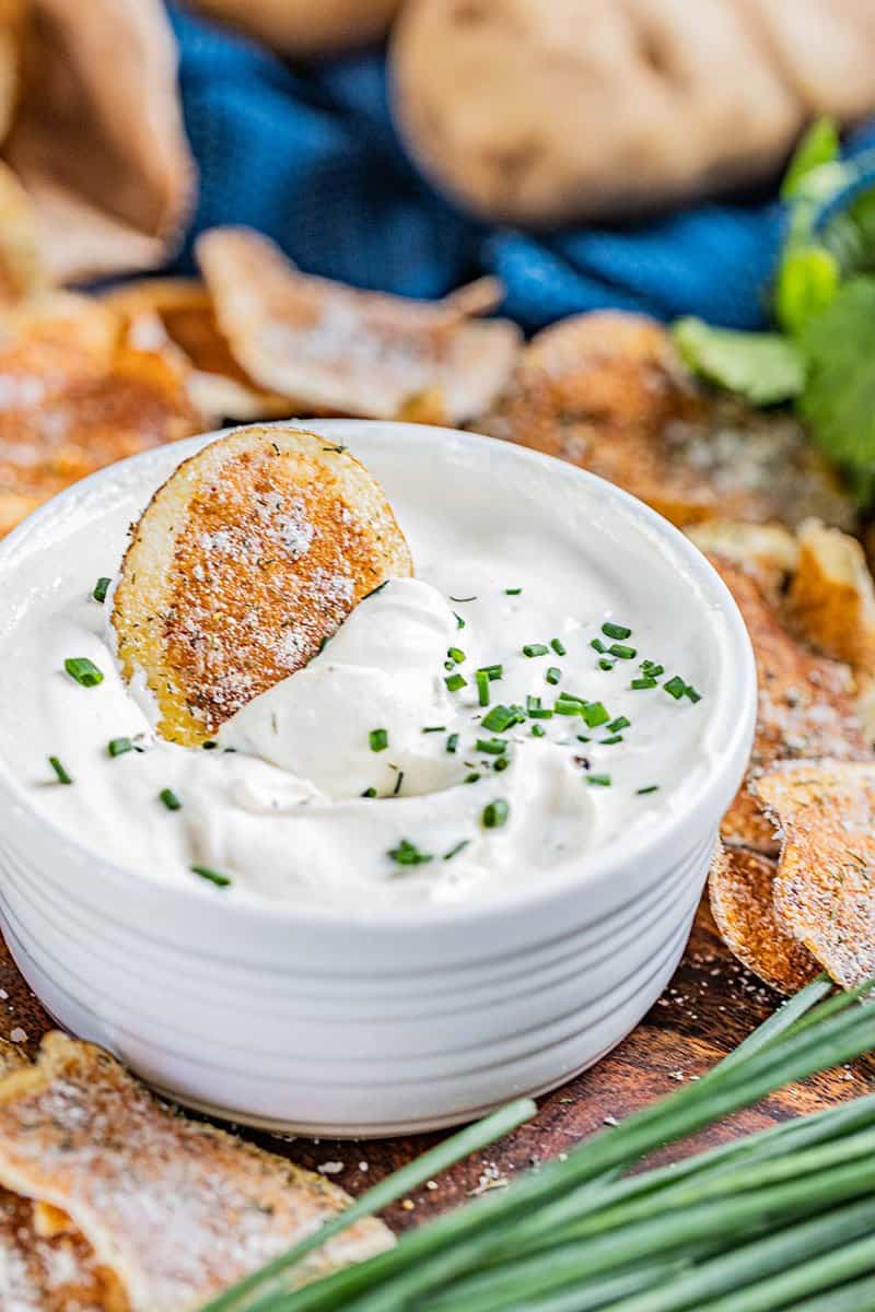 A homemade kettle chip dipped in French onion dip.