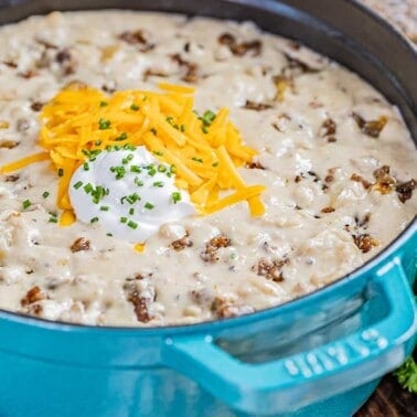 Close up view inside a pot full of creamy sausage potato soup.