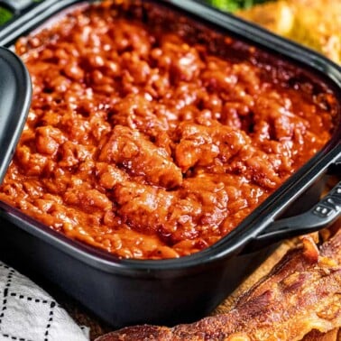 Homemade pork and beans in a square dish.