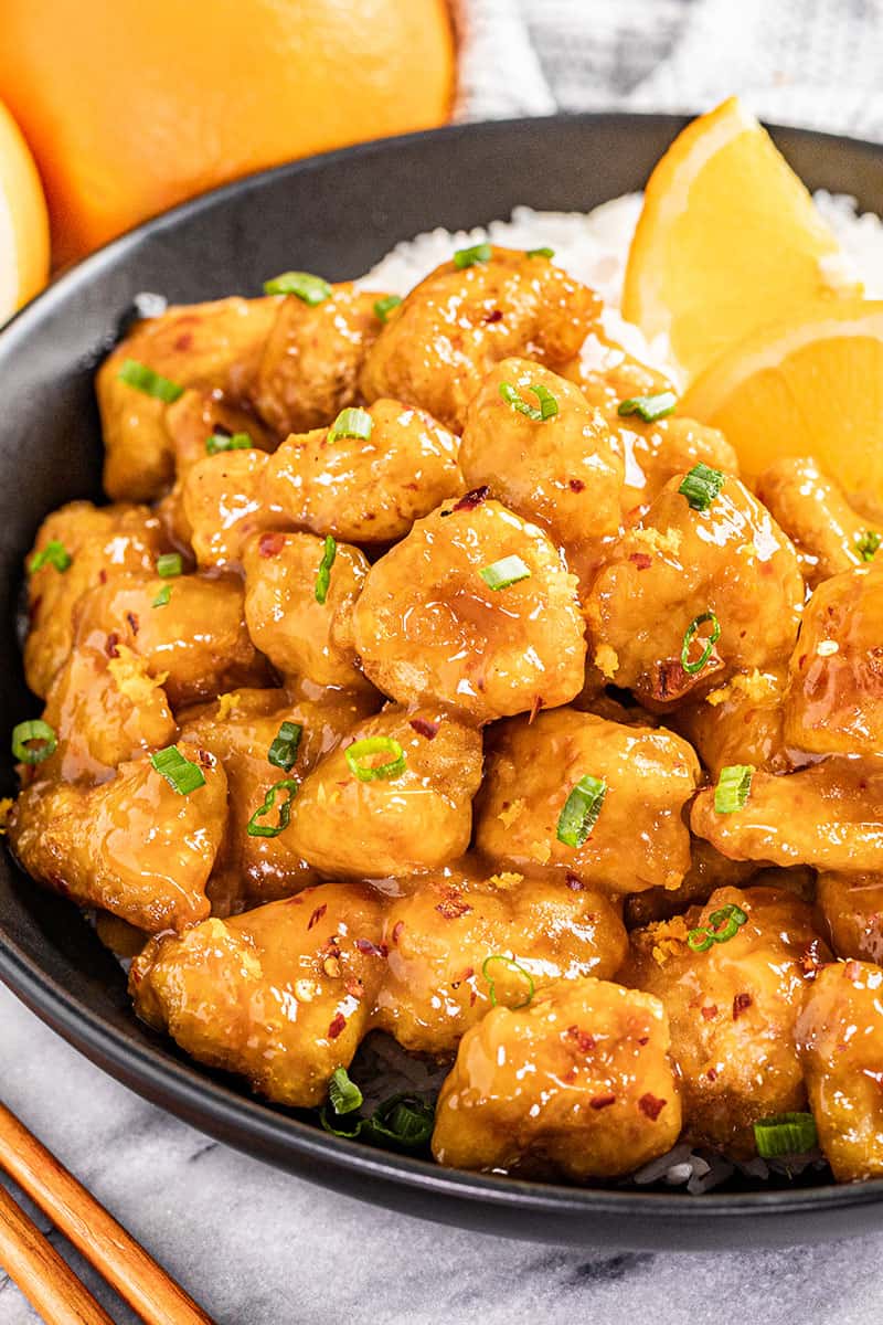 Orange chicken on a dinner plate.