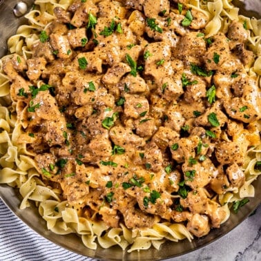 Overhead view of beef and noodles in a skillet.