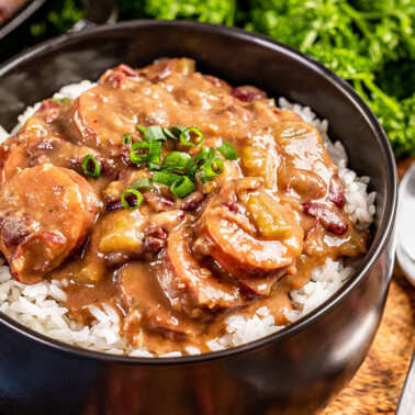 Red beans and rice in a black bowl.