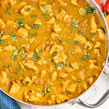 Overhead view of coconut curry in a large pot.