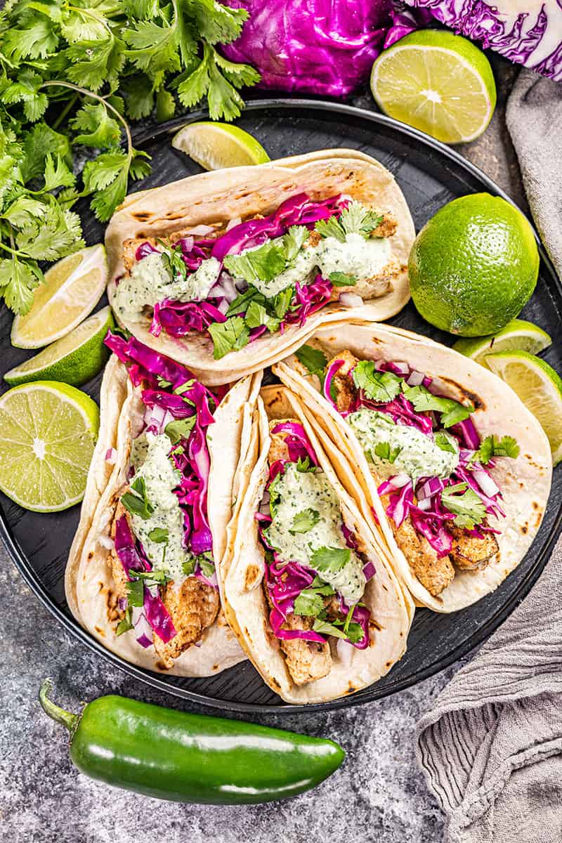 Overhead view of fish tacos on a serving tray.