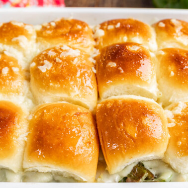 Cheesesteak sliders in a baking dish.