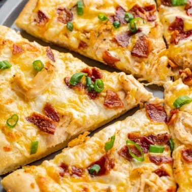 Chicken bacon ranch pizza cut into slices.